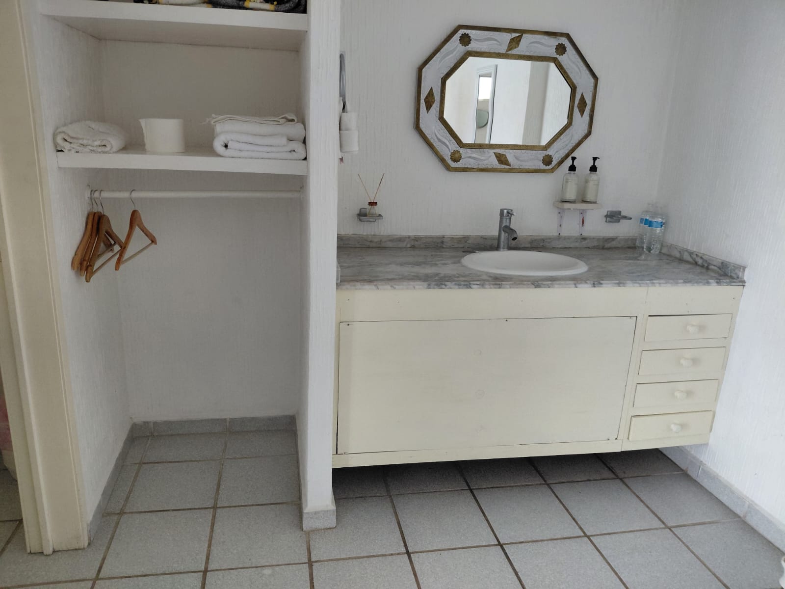 Lavabo, espejo y almacenamiento de una habitación del hotel.